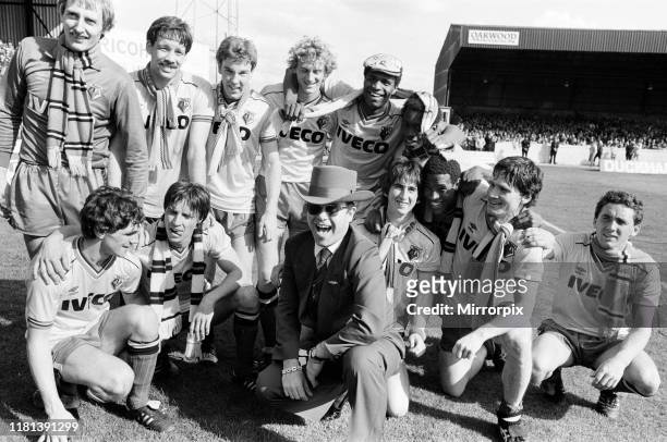Elton John and the Watford side pose for the photographers after their match against Liverpool. 14th May 1983.