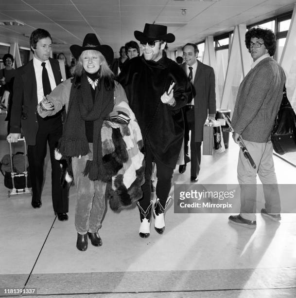 Elton John and Zandra Rhodes at Heathrow. 11th January 1981.