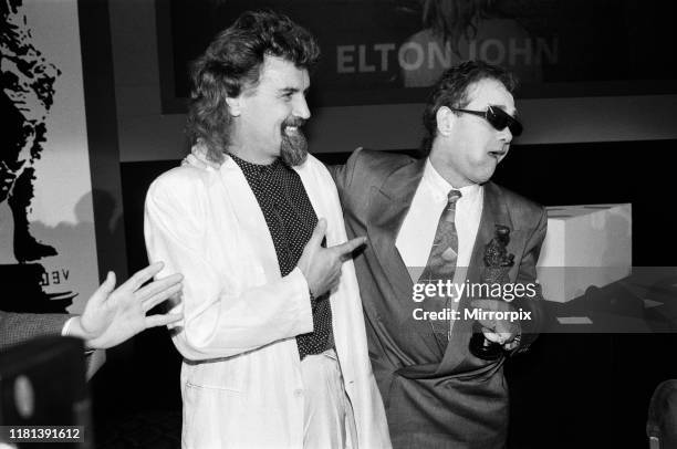 The Ivor Novello Awards at Gorsvenor House, London; pictured, Billy Connolly and Elton John. 7th April 1986.