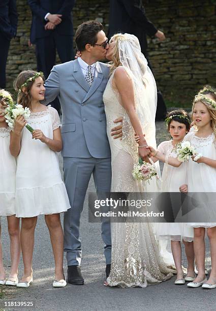Kate Moss and Jamie Hince kiss outside the church after getting married on July 1, 2011 in Southrop, England.
