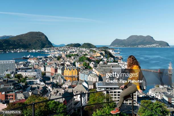 woman tourist at viewpoint on top of mount aksla - alesund, norway - alesund stock pictures, royalty-free photos & images