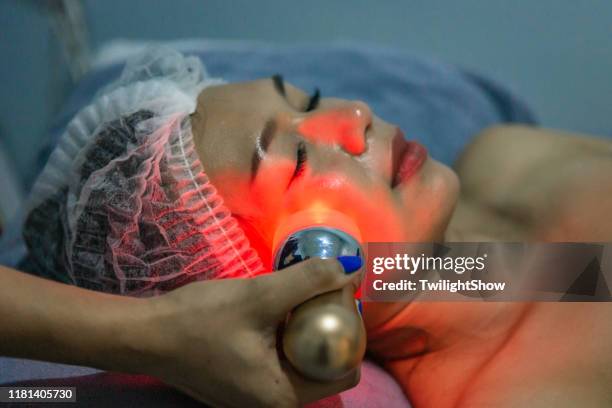 woman doing service with new laser technology of hardware cosmetology, young woman getting laser on face - laser face stock pictures, royalty-free photos & images