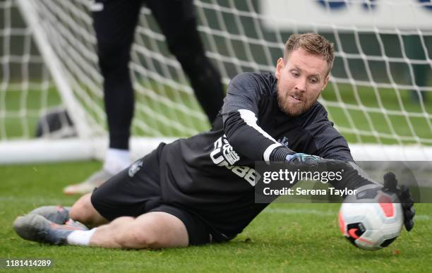 Goalkeeper Rob Elliot dives to make a save during the Newcastle United Training Session at the Newcastle United Training Centre on October 16, 2019...