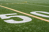 view of fifty yard line on sideline of football field