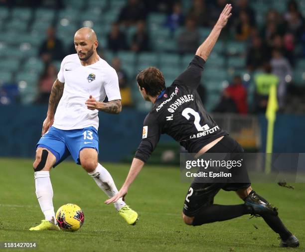 Fyodor Kudryashov of FC Sochi vies for the ball with Mario Fernandes of FC CSKA Moscow during the Russian Premier League match between FC Sochi v FC...