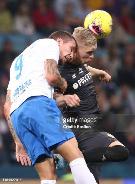 Anton Zabolotny of FC Sochi vies for the ball with Hordur Bjorgvin Magnusson of FC CSKA Moscow during the Russian Premier League match between FC...