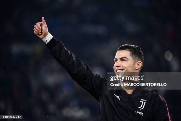 Juventus' Portuguese forward Cristiano Ronaldo acknowledges the public prior to the Italian Serie A football match Juventus vs AC Milan on November...