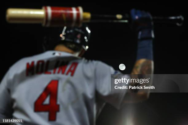 The moon shines behind Yadier Molina of the St. Louis Cardinals as he stands on deck in the sixth inning against the Washington Nationals during game...