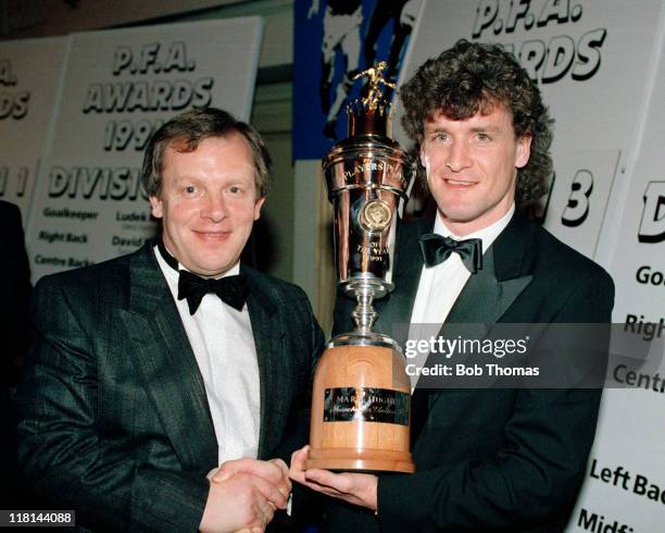 Chief Executive Gordon Taylor congratulates Manchester United striker Mark Hughes who won the PFA Player of the Year award during the PFA awards...