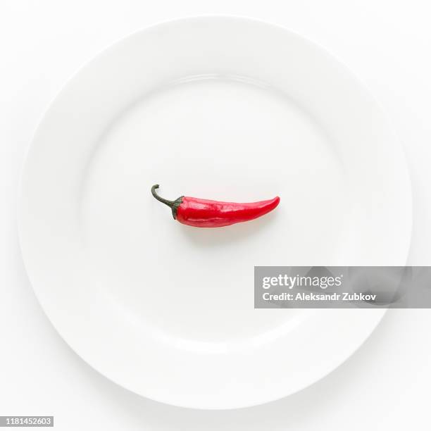 red hot chili pepper on white plate on white background. - pimenta de caiena imagens e fotografias de stock