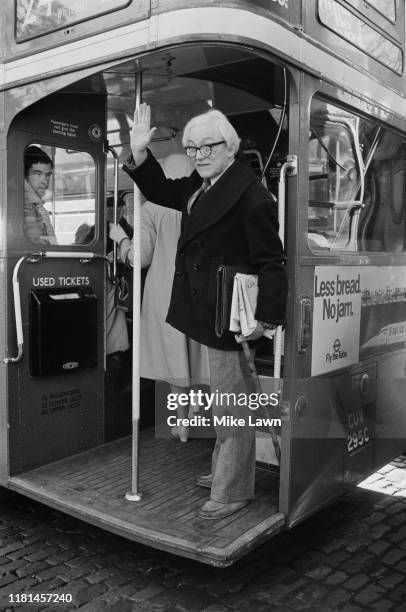 British Labour Party politician Michael Foot waves at the press as he leaves on a double-decker bus, London, UK, 11th November 1980.