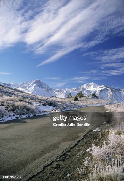 empty road toward snow capped mountains - mammoth lakes stock pictures, royalty-free photos & images