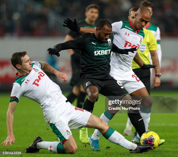 Aleksandr Kolomeytsev and Murilo Cerqueira of FC Lokomotiv Moscow and Manuel Fernandes of FC Krasnodar vie for the ball during the Russian Football...