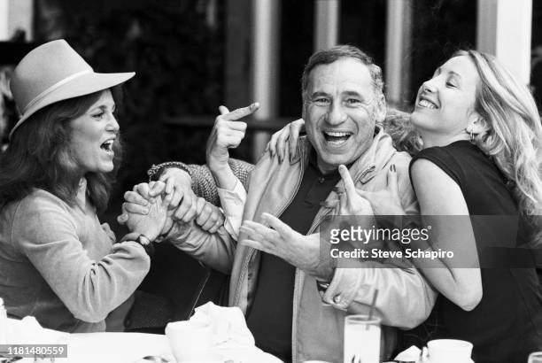 View of, from left, American actress Madeline Kahn , director and actor Mel Brooks, and actress Teri Garr at a restaurant as they clown around...