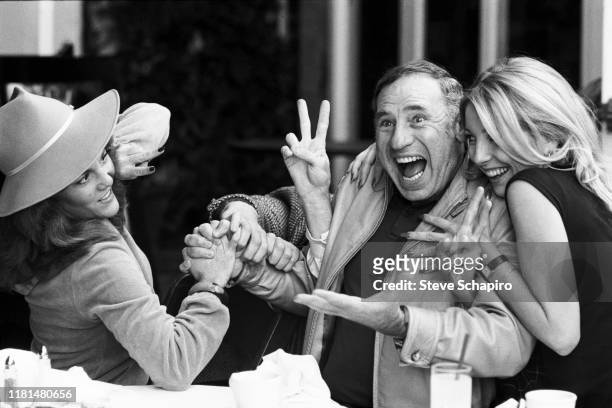 View of, from left, American actress Madeline Kahn , director and actor Mel Brooks, and actress Teri Garr at a restaurant as they clown around...