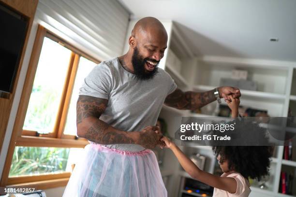 funny father with tutu skirts dancing like ballerinas - funny ballet stock pictures, royalty-free photos & images