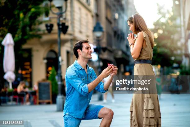 young man proposing to a woman - boyfriend day stock pictures, royalty-free photos & images