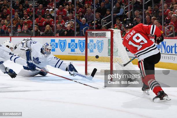 Jonathan Toews of the Chicago Blackhawks scores on goalie Michael Hutchinson of the Toronto Maple Leafs in the first period at the United Center on...