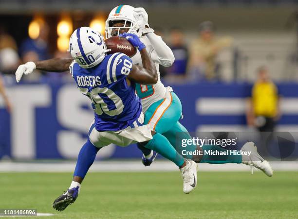 Chester Rogers of the Indianapolis Colts makes a reception as Reshad Jones of the Miami Dolphins defends during the second half at Lucas Oil Stadium...