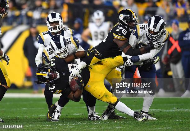 Trey Edmunds of the Pittsburgh Steelers is tackled by Aaron Donald and Dante Fowler of the Los Angeles Rams during the fourth quarter at Heinz Field...
