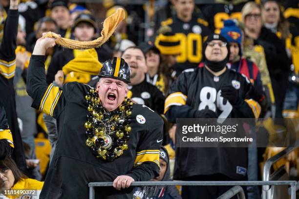 Pittsburgh Steelers fan waves a terrible towel during the NFL football game between the Los Angeles Rams and the Pittsburgh Steelers on November 10,...