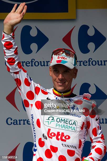 Polka dot jersey of best climber, Belgium's Philippe Gilbert, waves on the podium at the end of the 198 km and third stage of the 2011 Tour de France...