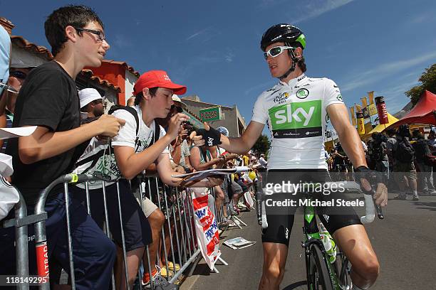 Geraint Thomas of Great Britain and team Sky Procycling signs autographs ahead of the start of Stage 3 of the 2011 Tour de France from Olonne sur Mer...