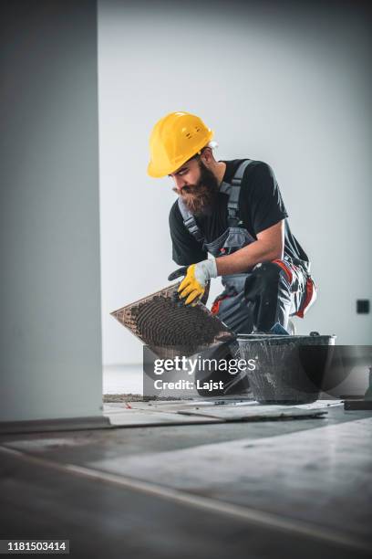 laying a tile floor - tiler stock pictures, royalty-free photos & images