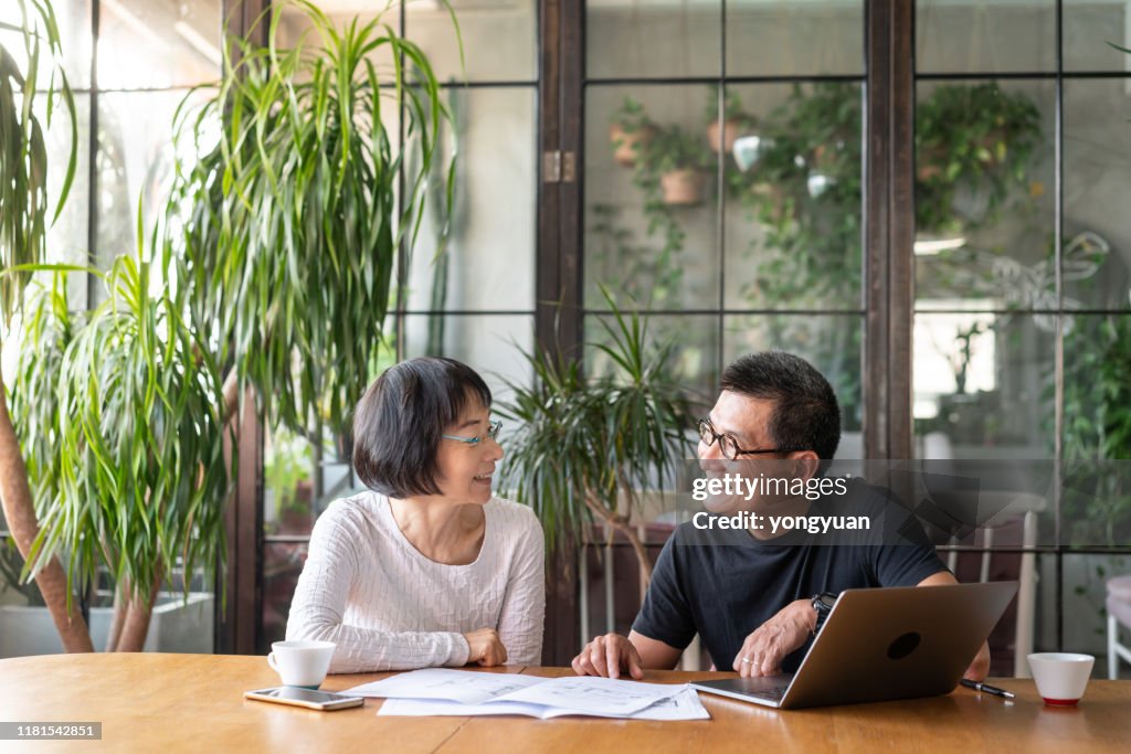 Asian couple talking about buying a new house