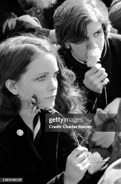 In front of the Lincoln Memorial, two protestors listen to speeches before marching to the Pentagon October 21, 1967.