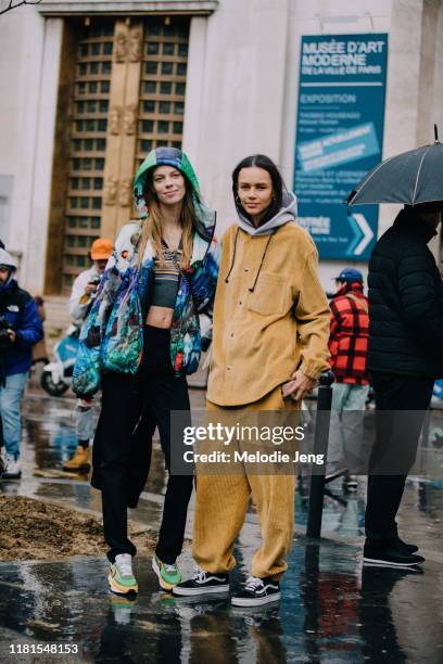 Models Lexi Boling and Binx Walton after the Sacai show during Paris Fashion Week Fall/Winter 2019 on March 04, 2019 in Paris, France. Lexi wears a...