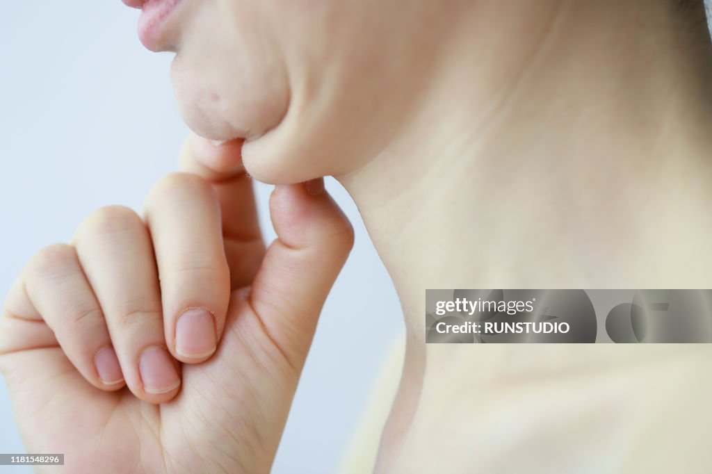 Mature woman touching double chin,close up