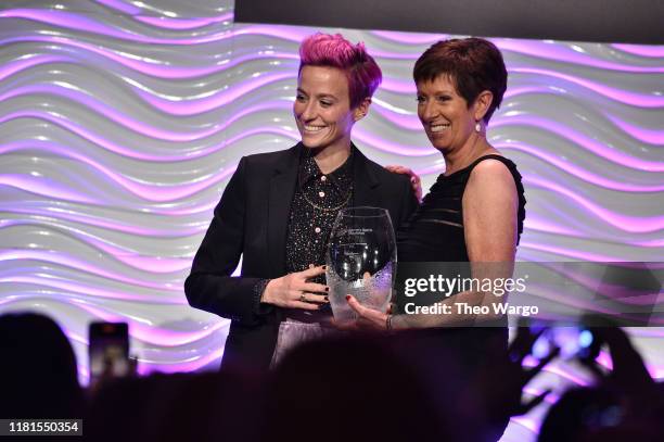 Megan Rapinoe accepts her WSF Sportswoman Of The Year Award from Muffet McGraw at The Women in Sports Foundation 40th Annual Salute to Women in...