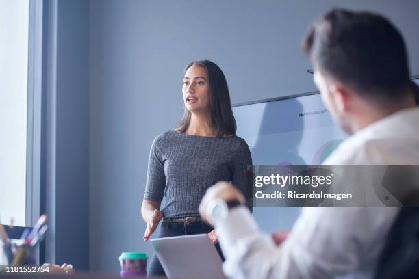 woman conducting a conference in the boardroom - latin script stock pictures, royalty-free photos & images