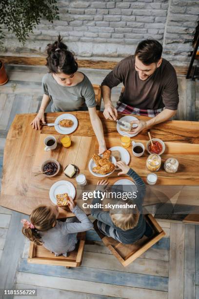 über dem blick auf eine familie, die am esstisch frühstückt. - breakfast family stock-fotos und bilder