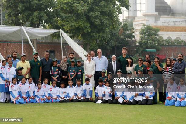 Prince William, Duke of Cambridge and Catherine, Duchess of Cambridge pose with players during their visit at the National Cricket Academy during day...