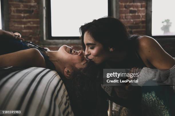 two affectionate women at home - images of lesbians kissing stock pictures, royalty-free photos & images