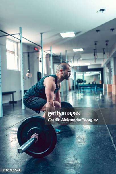 male bodybuilder working out with barbell in gym - deadlift stock pictures, royalty-free photos & images