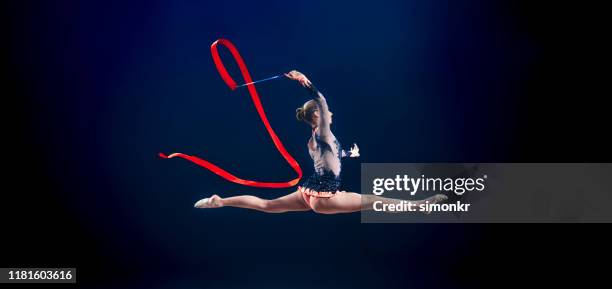 gymnast performing with ribbon - rhythmic gymnastics stock pictures, royalty-free photos & images
