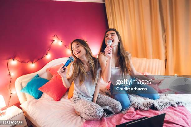 female slumber party - girl singing stock pictures, royalty-free photos & images