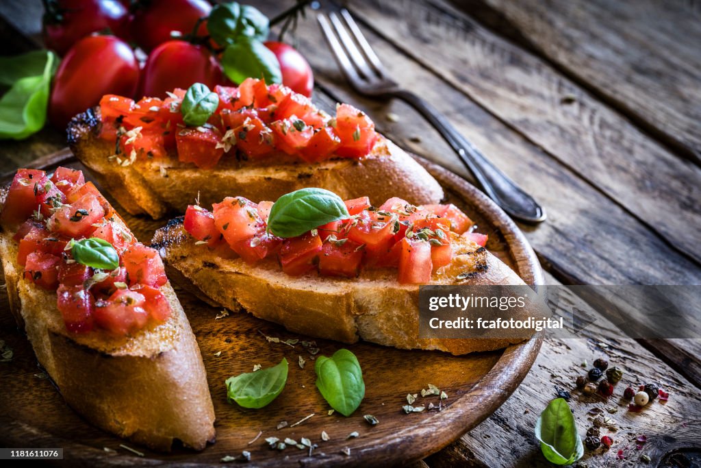 Homemade Italian bruschetta on rustic wooden table