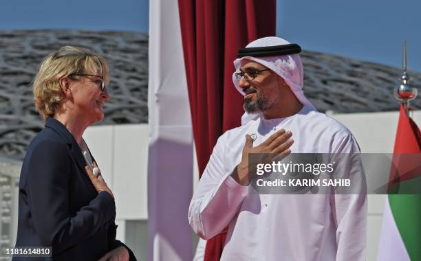 Sheikh Khaled bin Mohammed bin Zayed al-Nahyan welcomes Claude Chirac, late Jacques Chirac's daughter, at the Louvre in Abu Dhabi on November 11,...