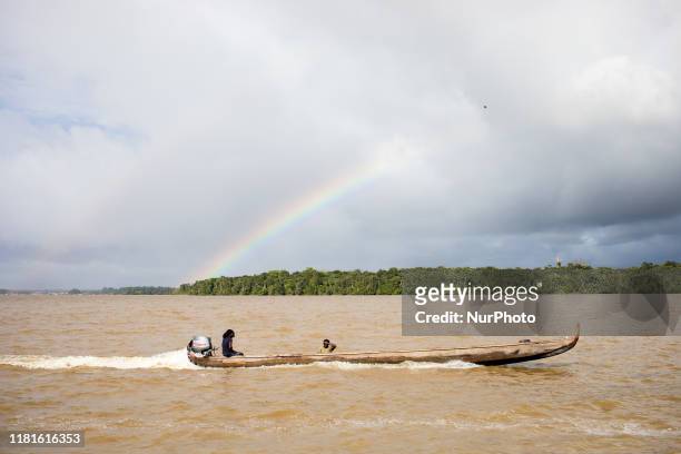 Saint-Laurent-du-Maroni, France, July 4, 2019. A Bushinengue on his canoe on the Maroni River near Suriname not far from the city of Saint-Laurent.
