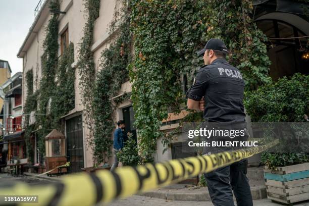 Turkish police officer stands guard ouside the Mayday Rescue offices on November 11 in the Karakoy district of Istanbul, following the discovery of...