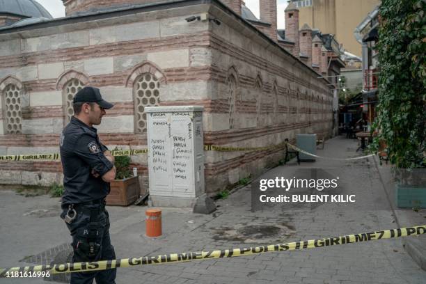 Turkish police officer stands guard ouside the Mayday Rescue offices on November 11 in the Karakoy district of Istanbul, following the discovery of...