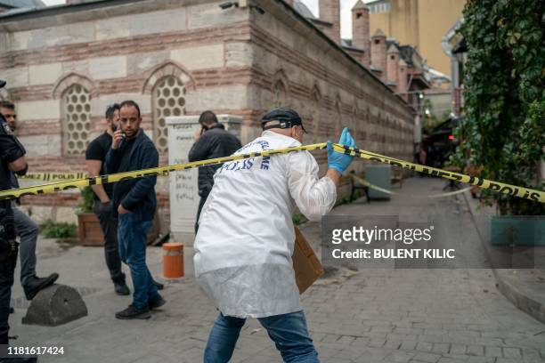 Turkish police officer arrives at the scene of the Mayday Rescue offices on November 11 in the Karakoy district of Istanbul, following the discovery...