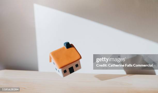falling house - price drop stock pictures, royalty-free photos & images
