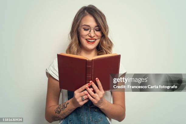 woman with glasses reading a book - storytelling stock pictures, royalty-free photos & images