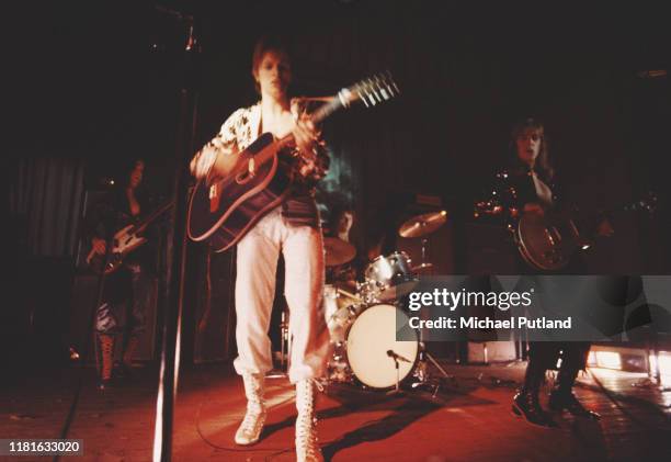 David Bowie performs live on stage with his backing group The Spiders From Mars on the first night of the Ziggy Stardust Tour at Borough Assembly...