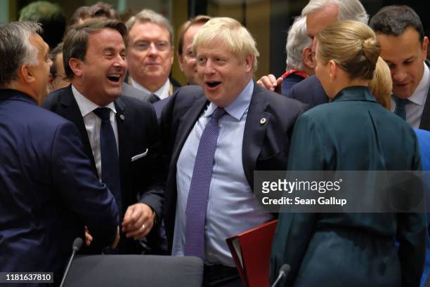 Prime Minister Boris Johnson and Luxembourg Prime Minister Xavier Bettel share a laugh at a summit of European Union leaders on October 17, 2019 in...